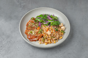 fried rice with chicken breast and tofu on gray background	