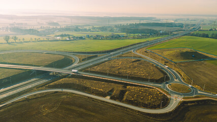 a roundabout connecting several roads including a highway and an expressway on a beautiful sunny...