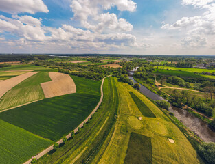 green fields and meadows, the prona river, spring on a beautiful sunny day. Idyllic landscape from a drone