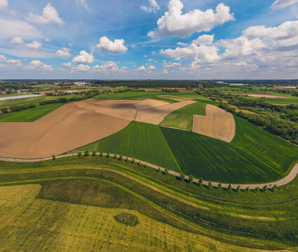 green fields and meadows, the prona river, spring on a beautiful sunny day. Idyllic landscape from a drone