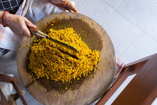 Raw Spices or in Balinese called Bumbu Megenep Being Chopped on a Wooden coaster with Blakas or Belakas, a Traditional Sharp Weapon from Bali