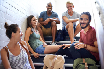 University, steps and students with happiness, friends and smile together, classmates and conversation. Campus, women and men in course for education with scholarship, relax and people on stairs