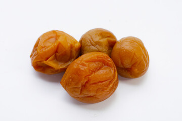 Pickled plums on white background.