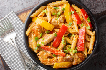 Jamaican Rasta Pasta tossed in Jamaican jerk seasoning, chicken, coconut milk and with colourful...