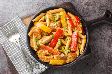 Rasta Pasta is a Penne cooked in rich creamy sauce with Jerk Chicken, sauteed onions, Sweet...