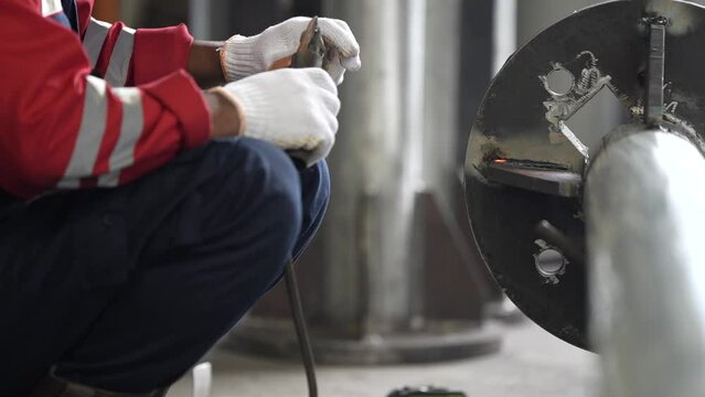 the welder is welding iron poles. welding iron poles. welding in manufacturing plants