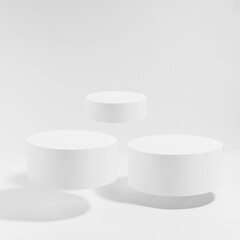 Three white round podiums levitate, mockup on white background with shadow. Template for...