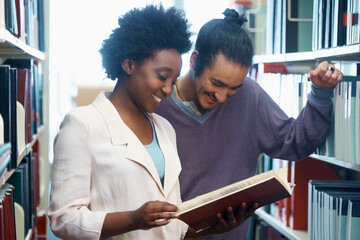 Man, woman and friends at library or reading book together as students for education, research or...
