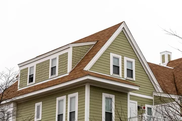 Fotobehang Exterior view of a newly built family house with shed dormer windows on a winter day in Brighton, MA, USA © Baharlou