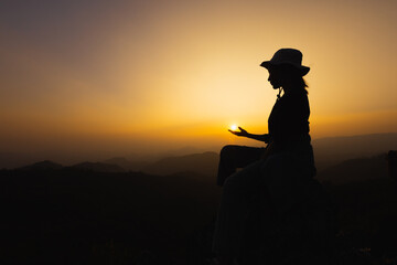 silhouette of woman praying to god Highest faith in religion and belief in God based on prayer. The...