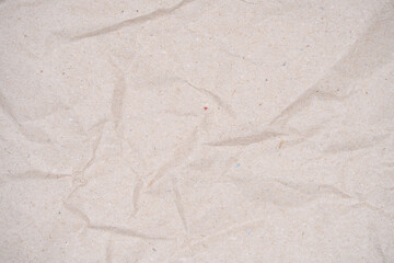 Soft brown recycled paper with a crumpled texture, suitable for eco-friendly project backgrounds.