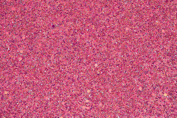 Sparkling pink sequin texture in close-up, suitable for backgrounds with a festive or glamorous...