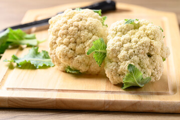 Organic cauliflower on cutting wooden board for cooking