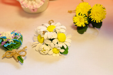 Artificial flowers made of polymer clay, handmade. Soft focus.