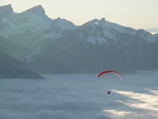 Paraglider over clouds in Switzerland