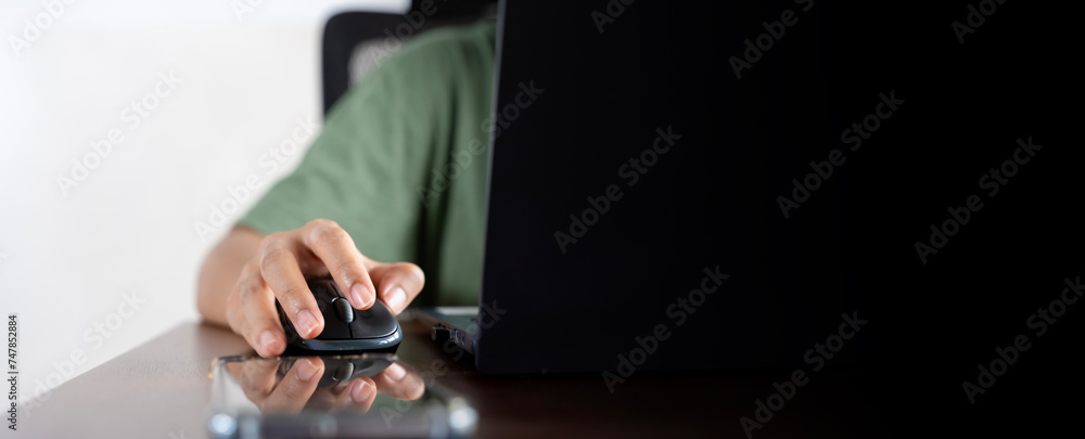 Poster woman hand using the mouse of a computer using a laptop, panoramic banner. browsing the internet in 