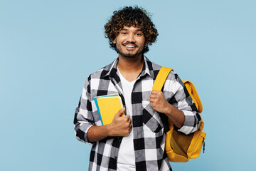 Young smiling happy smart Indian boy student he wears shirt casual clothes backpack bag hold books...