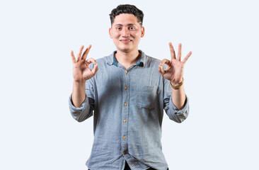 Naklejka premium Interpreter person gesturing OK in sign language. Smiling young man gesturing APPROVED in sign language