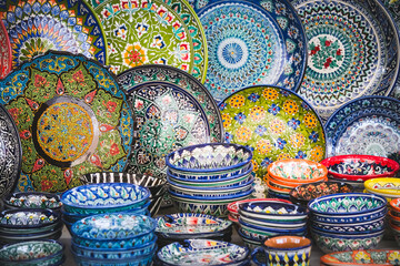 Multi-colored ceramic products with oriental ornaments at the Siab Bazaar in the ancient city of Samarkand in Uzbekistan, Siyob bozor - obrazy, fototapety, plakaty