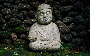 Buddhist sculpture. Botanical garden - Monte palace on spring day. Oriental part of the garden. Madeira island