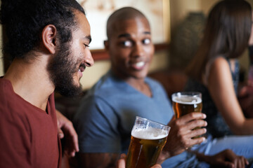 Friends, beer and chill at pub, smile and relax indoor for conversation and bonding at night to celebrate. Male people, bar and happy for social, guys and alcohol together and laughing for fun.
