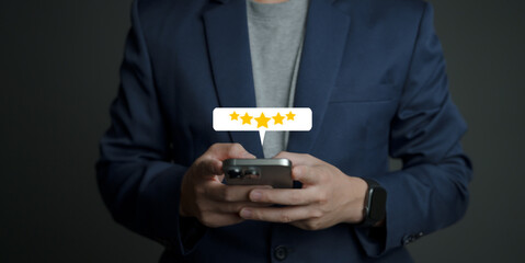 close up Man hand using smartphone with popup five star icon for feedback review satisfaction service, Customer service experience and business satisfaction survey.
