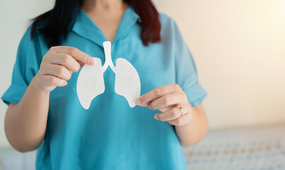 Woman holding lungs decorative model. World tuberculosis TB day, pneumonia, respiratory diseases...