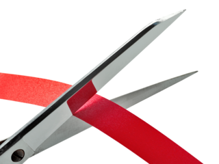 Old and rusty Scissors cutting a red ribbon. clipping path
