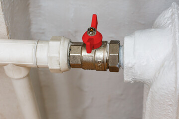 Ball valve with red handle when closed. Shut-off valves for the heating system of the apartment. Turn off the faucet.