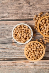 Chickpeas source and peeled barley in a basket wooden isolated on wood background
