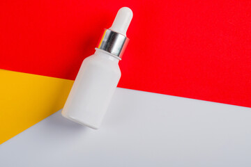 Plastic white tube for cream or lotion. Skin care or sunscreen cosmetic on yellow and red...