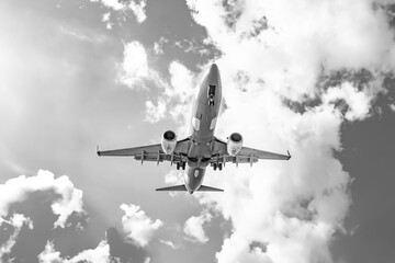 black and white photo: plane in the sky