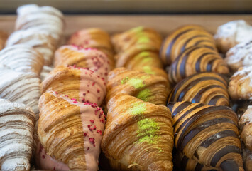 Croissants with various fillings on the shop window.