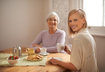 Portrait, happy woman and elderly mother drinking tea at breakfast, bonding and smile in house....