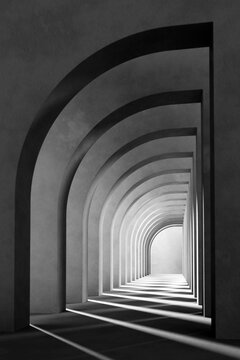 Fototapeta A black and white background with light coming through the building structure.