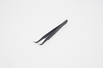 Black iron cell phone tweezers from the side on a white background