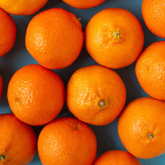 Many fresh oranges top view. Vibrant square photo of citrus fruits flat lay background. Vitamin C