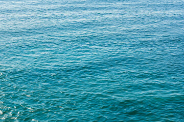 Blue sea water background. Water surface texture. Top view. Copy space.