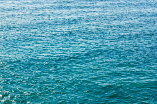 Blue sea water background. Water surface texture. Top view. Copy space.