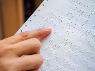 Braille Alphabet with hand Reading book document for Blind People 