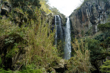 Fototapeta na wymiar View of the beautiful and tall waterfall in Salto da Farinha, Azores, Portugal.