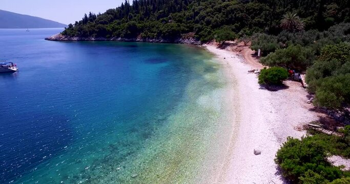 Aerial shot of Foki Beach in Kefalonia, Greece with clear turquoise waters and lush greenery