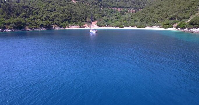 Foki beach in kefalonia with turquoise waters and a single yacht, aerial view
