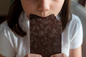 Girl Eating Chocolate Bar: Close-Up