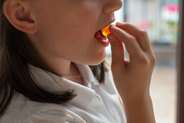 Child Girl Eating Gummy Candy