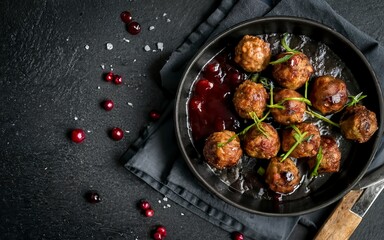 Homemade Swedish meatballs with lingonberries jam. Black background - obrazy, fototapety, plakaty
