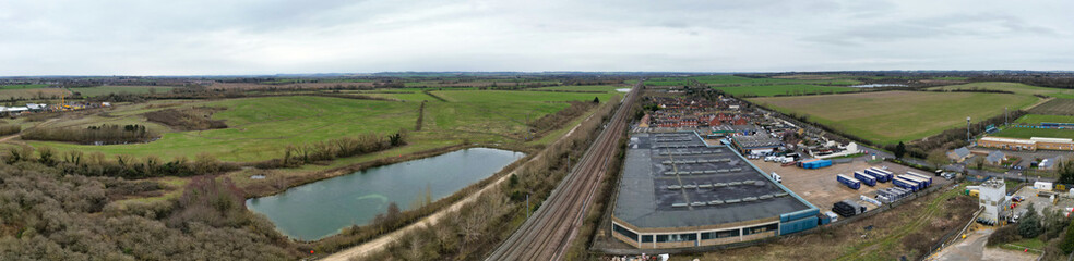 Fototapeta na wymiar High Angle Ultra Wide Panoramic View of Arseley Town of England UK. The Footage Was Captured During Cloudy and Rainy Day of Feb 28th, 2024