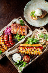 fast food set on plate. various meat Bavarian, Frankfurt, German grilled sausages and vegetables