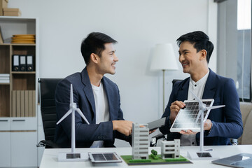 Asian business people using tablet for working technology and business, Renewable energy-based green businesses and global warming. Reduce CO2 emission.