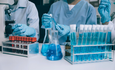 Science and medicine, scientist analyzing and dropping a sample into a glassware, experiments containing chemical liquid in laboratory on glassware, innovative and technology.